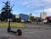 A sleek electric scooter parked on a scenic urban street.