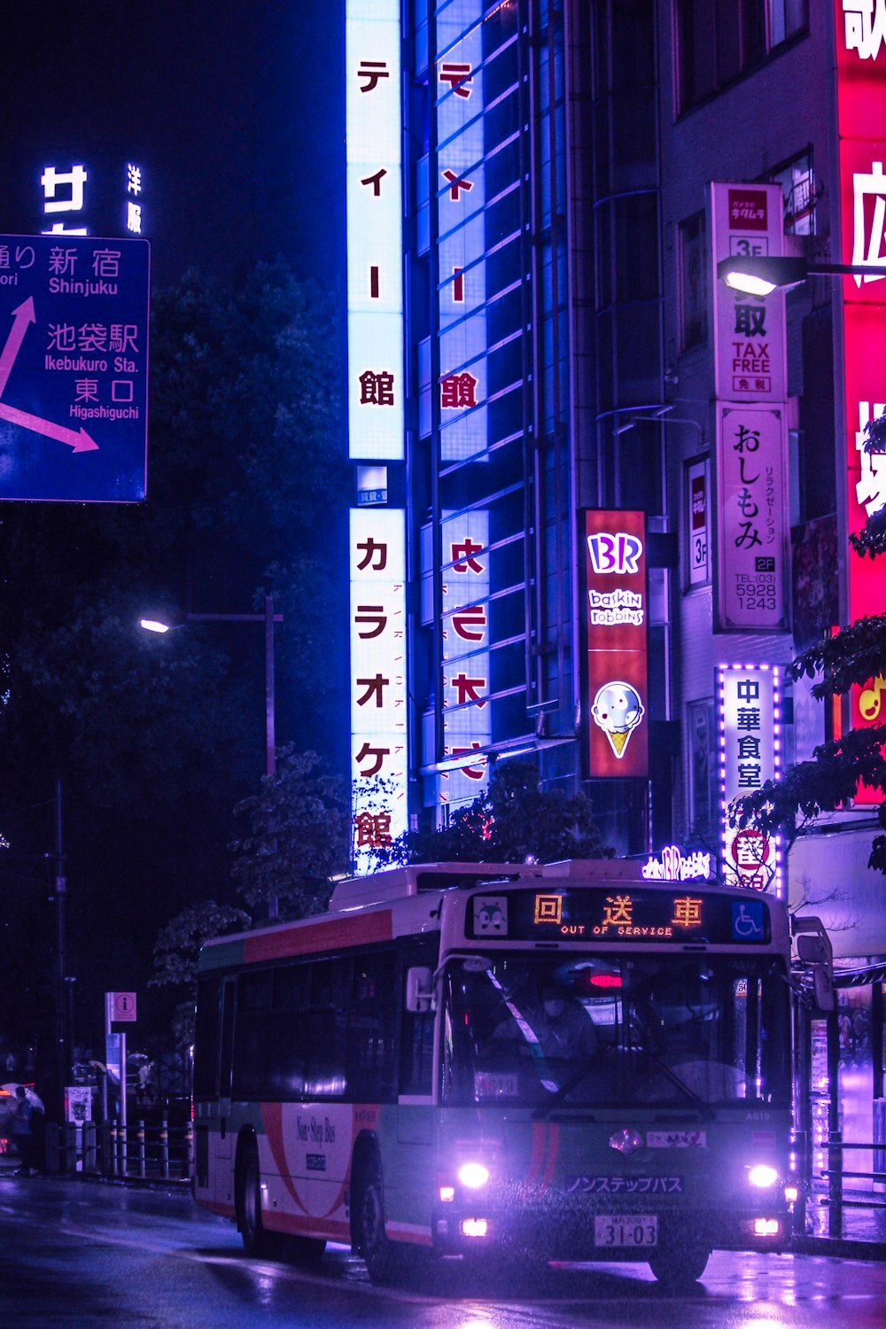 red double decker bus on road during night time