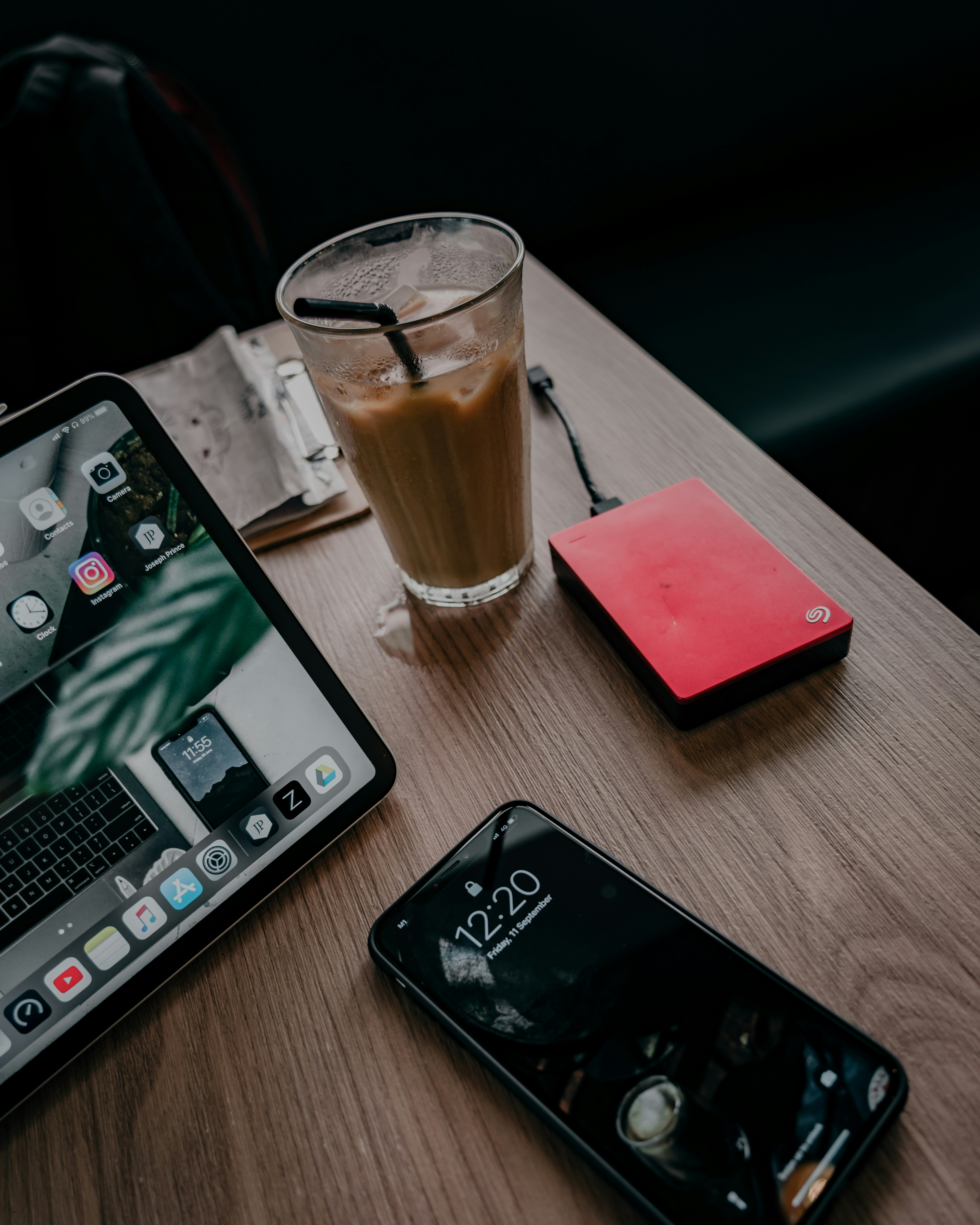black iphone 7 beside black iphone 5 on brown wooden table