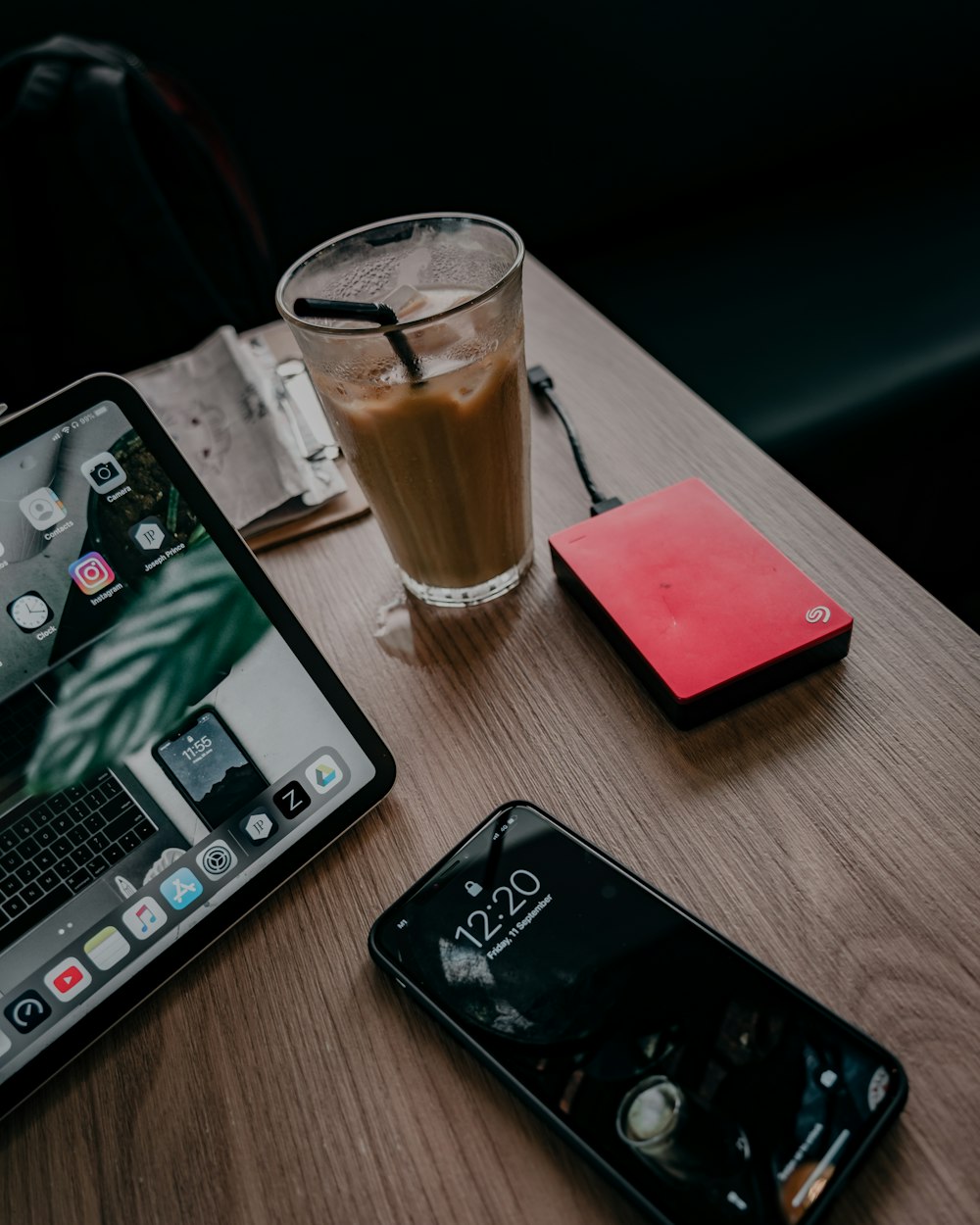 black iphone 7 beside black iphone 5 on brown wooden table