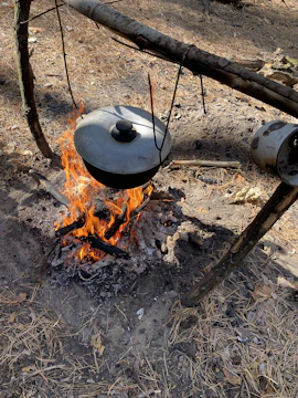 Close-up of a traditional cooking pot over an open fire