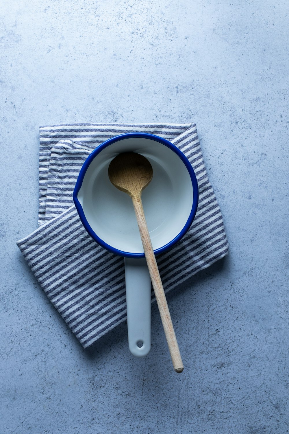 brown wooden spoon on white and blue ceramic plate