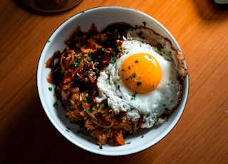 sunny side up egg on white ceramic bowl