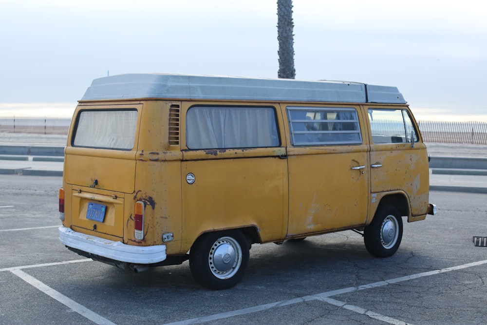 yellow van parked on gray concrete road during daytime