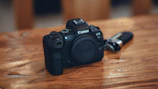 Canon EOS R6 Mark II camera resting on a wooden table with soft natural light.