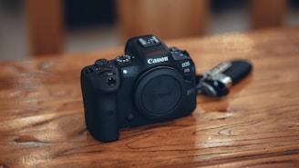 Canon R6 Mark II positioned beside a laptop, highlighting its versatility for creators.