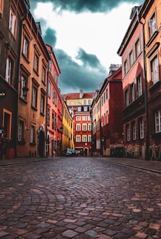 people walking on sidewalk between buildings during daytime