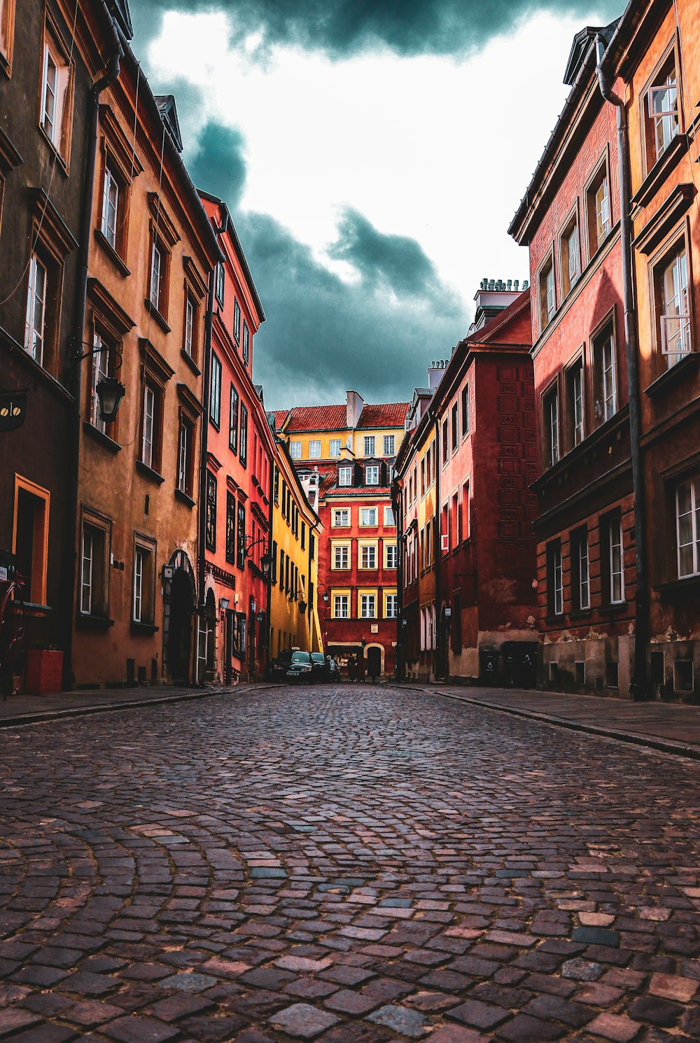 people walking on sidewalk between buildings during daytime