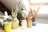 white ceramic jars on white table