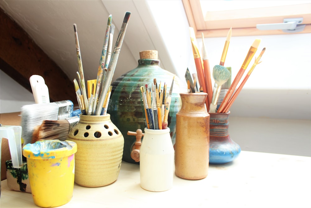 white ceramic jars on white table