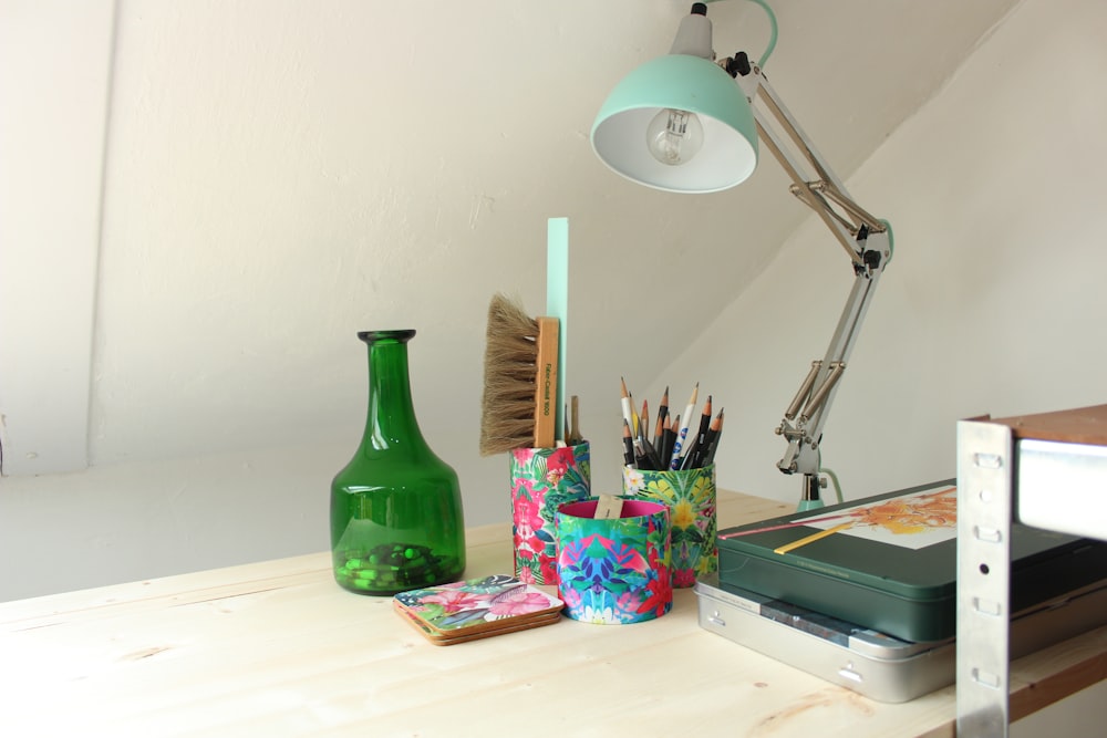 green glass bottle on white table