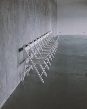 white folding chairs on gray floor