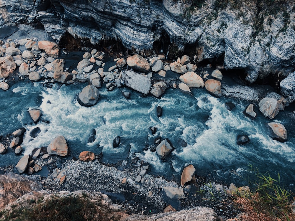 gray and black stone on river
