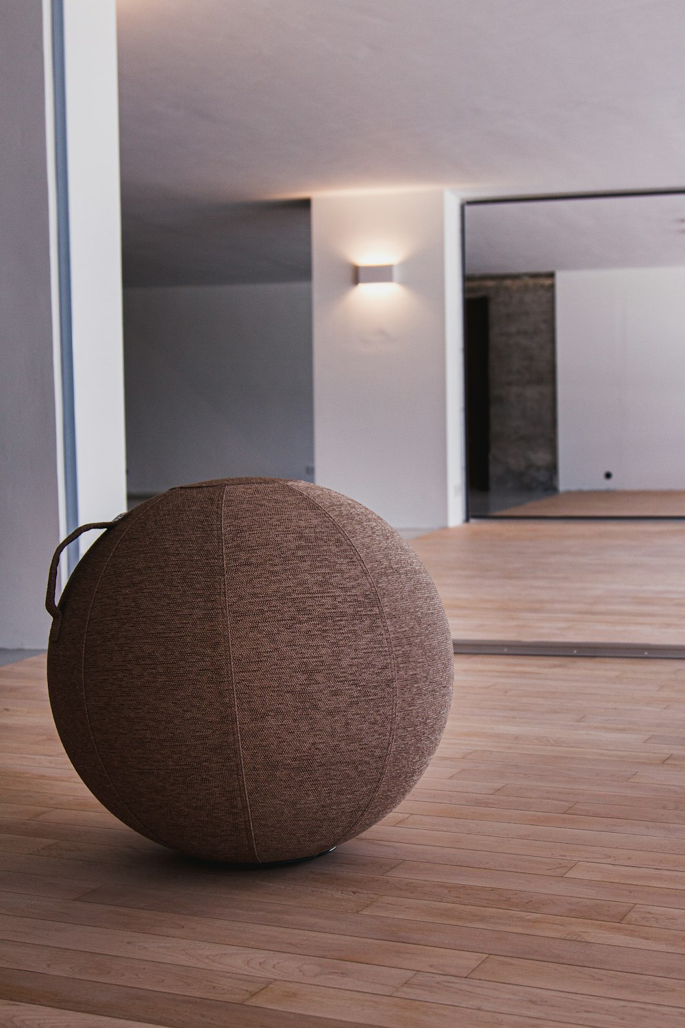 brown round cushion on brown wooden parquet floor