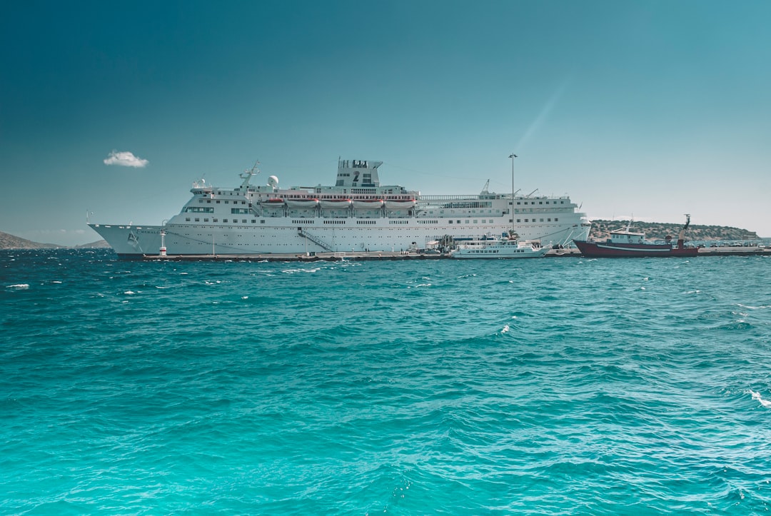 white cruise ship on sea under blue sky during daytime