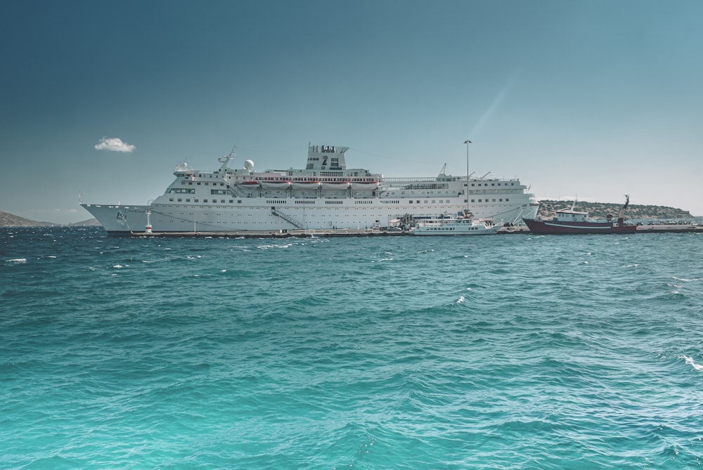 white cruise ship on sea under blue sky during daytime