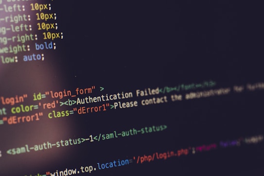 Lines of HTML and CSS code are displayed on a computer screen. The code features vahttps://whatismyerror.com/wp-content/uploads/2024/06/woman-traveling-in-france-2023-11-27-05-16-47-utc_Easy-Resize.com_.jpgus elements and styles, including an authentication error message highlighted in red, indicating a failed login attempt. The syntax is color-coded for better readability.