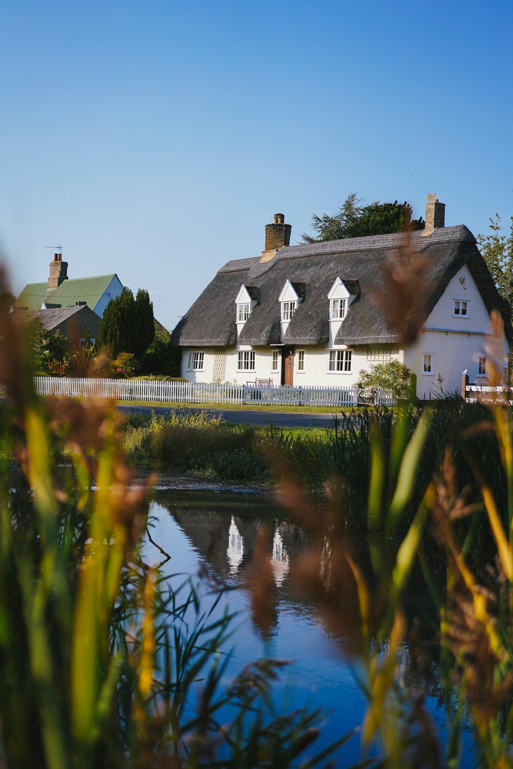 white and brown house beside river during daytime