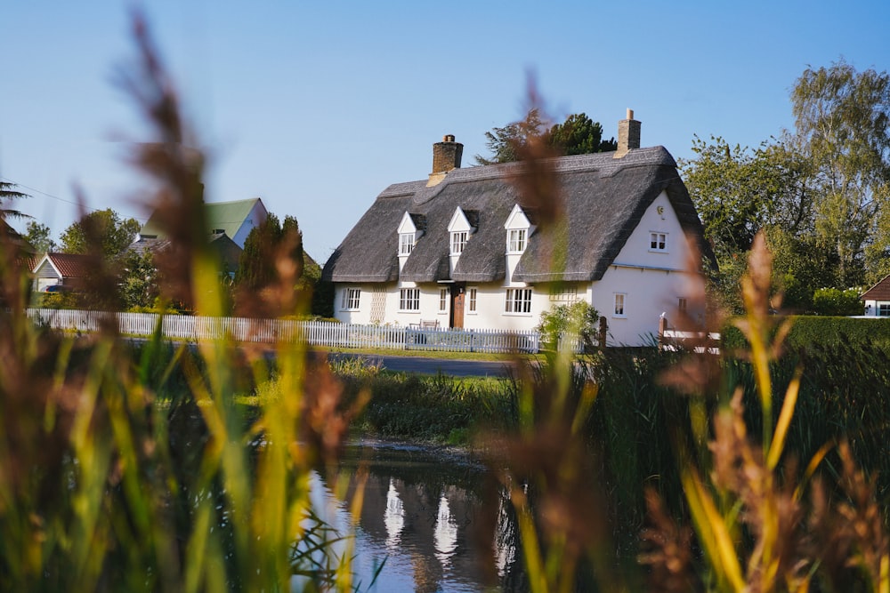 white and brown house beside river during daytime