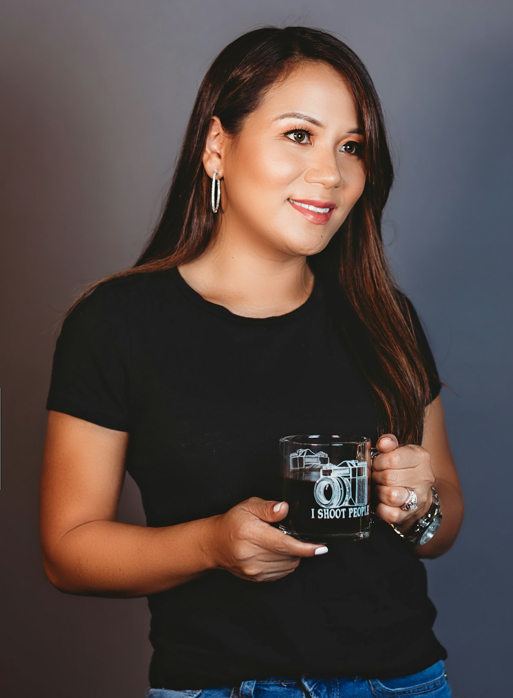 woman in black crew neck t-shirt holding black and white ceramic mug