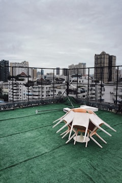 Artificial turf covering a rooftop terrace with seating area.