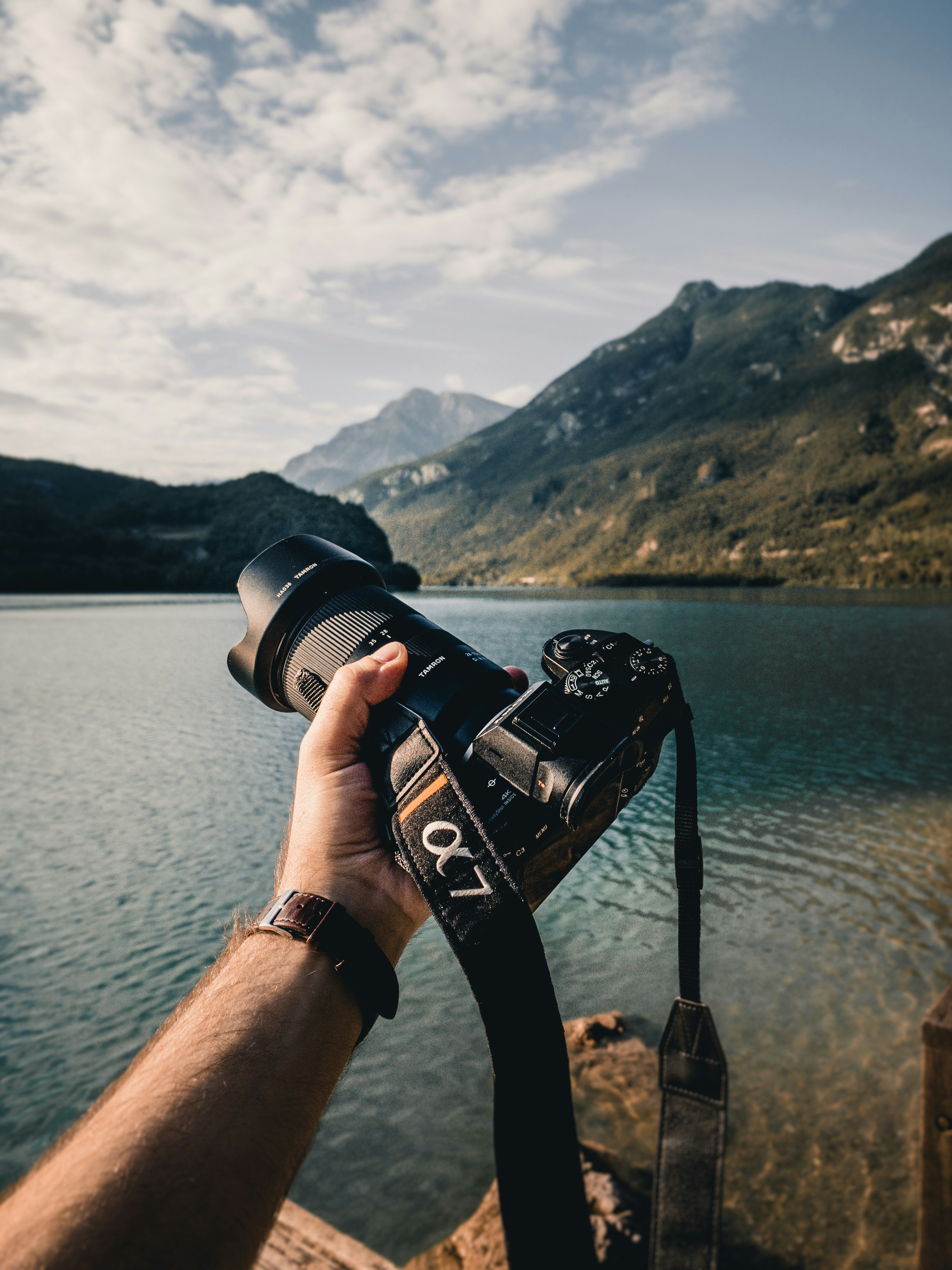 person holding black dslr camera