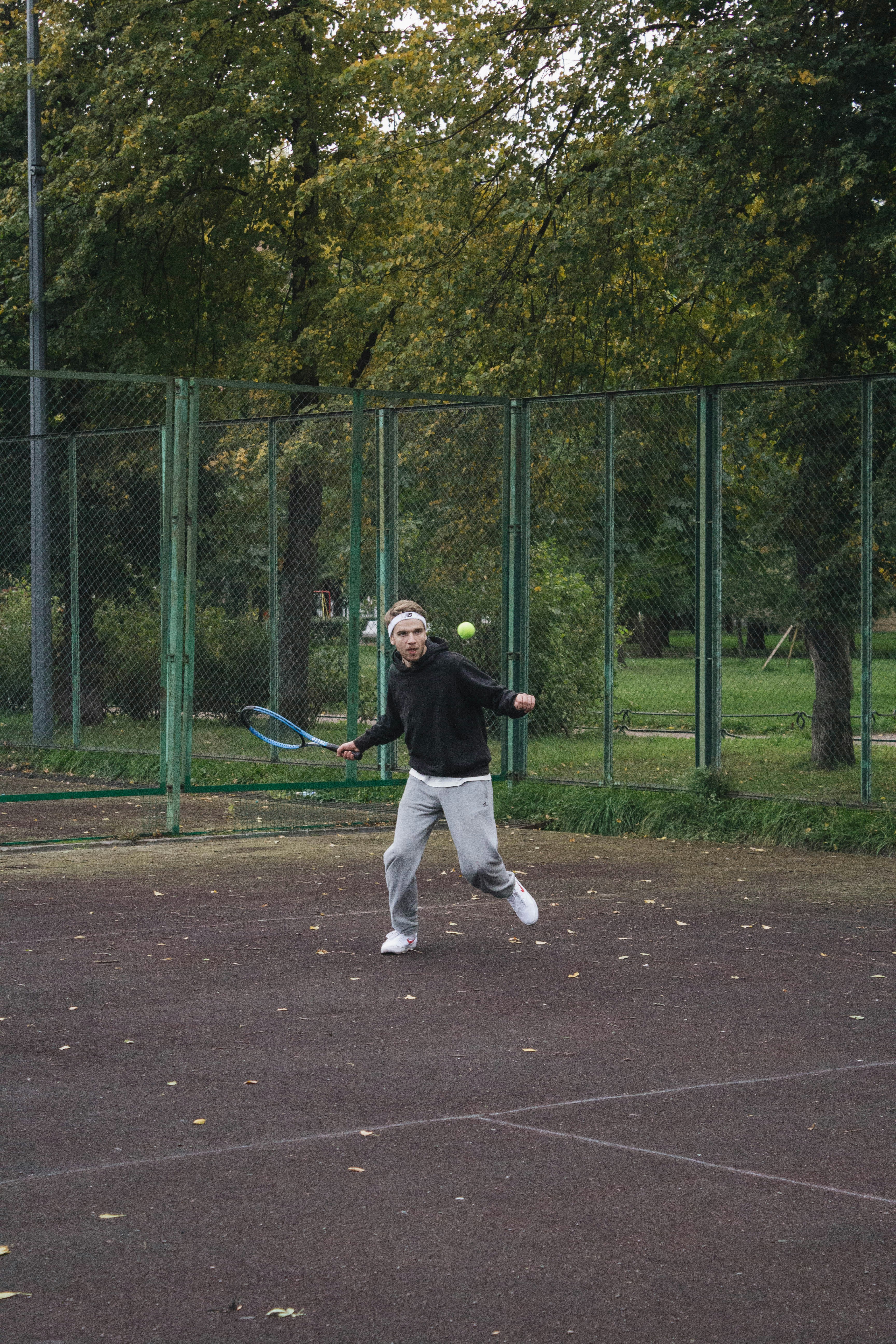 man in black shirt and white pants playing baseball during daytime
