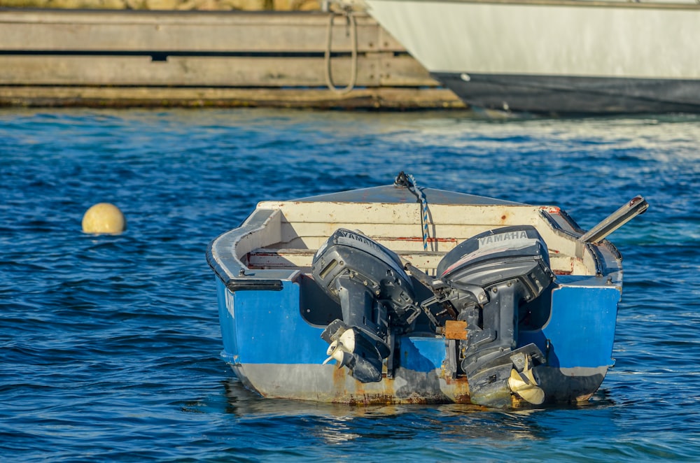 blue and white boat on water during daytime