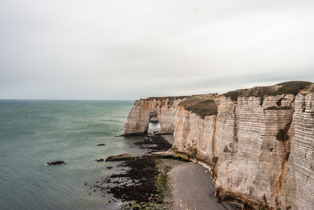 brown rock formation on sea during daytime