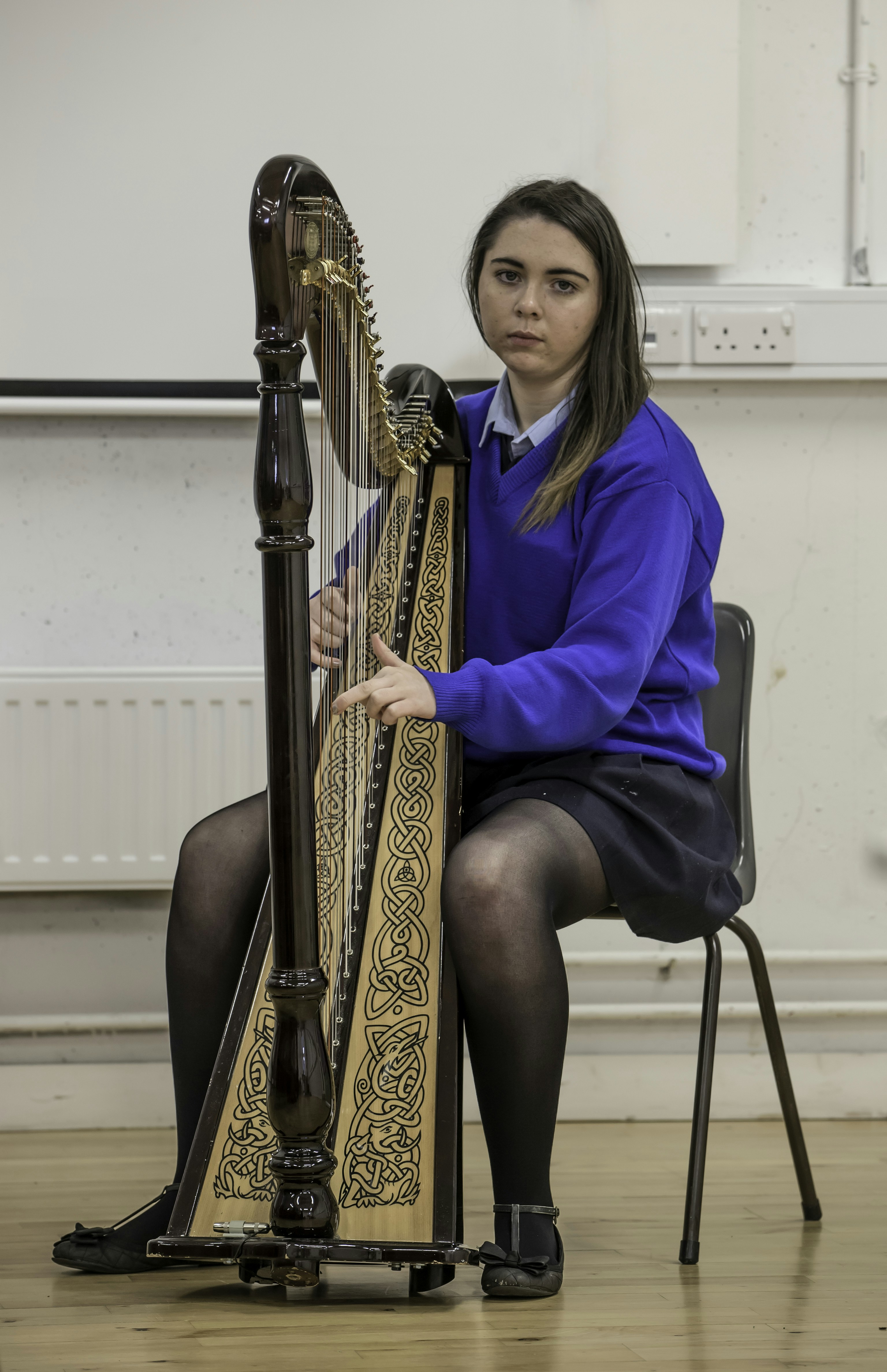 Young woman playing an Irish harp.