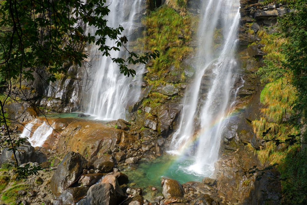 waterfalls on brown rocky mountain during daytime