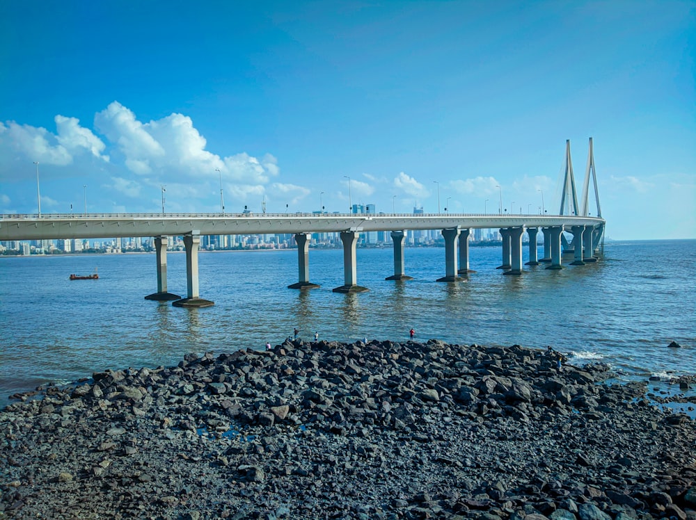 gray concrete bridge over the sea during daytime