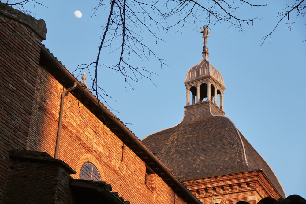 brown brick building under blue sky during daytime