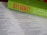 An open Bible lies on a surface, with the pages in focus. Resting on top is a bright green book titled 'DELIGHT!' in bold pink letters. The book cover includes cursive white text that reads 'Discipleship as a Way of Loving and...' The composition highlights religious and inspirational themes.
