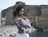 woman in white dress holding white flower