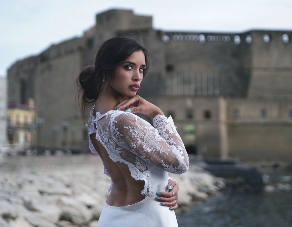 woman in white dress holding white flower