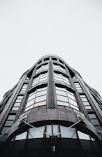 Wide-angle shot of a contemporary London building showcasing glass, concrete, and charcoal accents.
