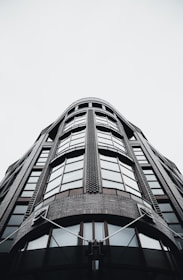 Wide-angle shot of a contemporary London building showcasing glass, concrete, and charcoal accents.