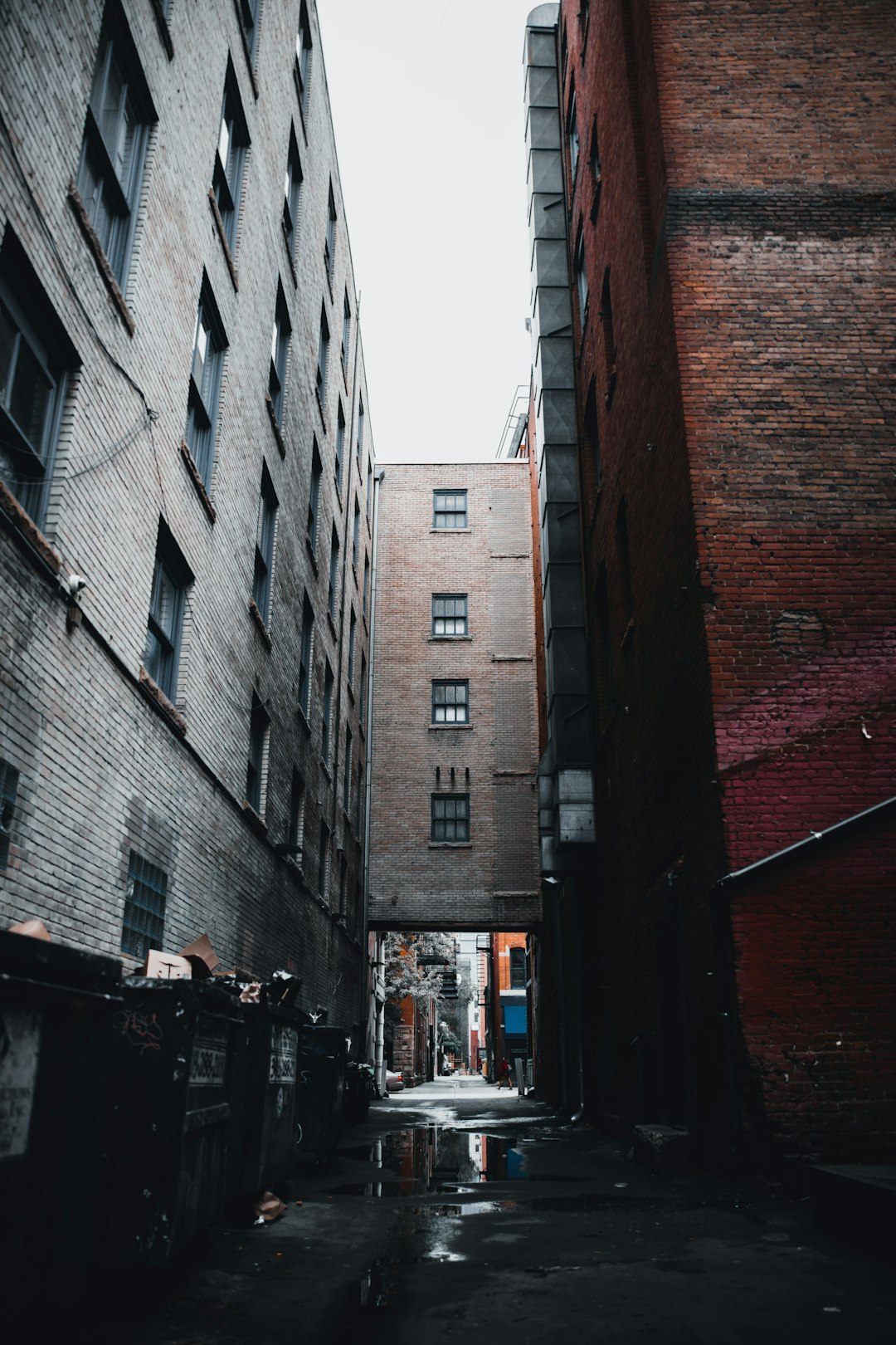 cars parked beside brown concrete building during daytime