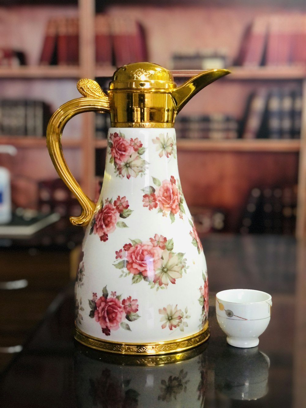 white and pink floral ceramic pitcher