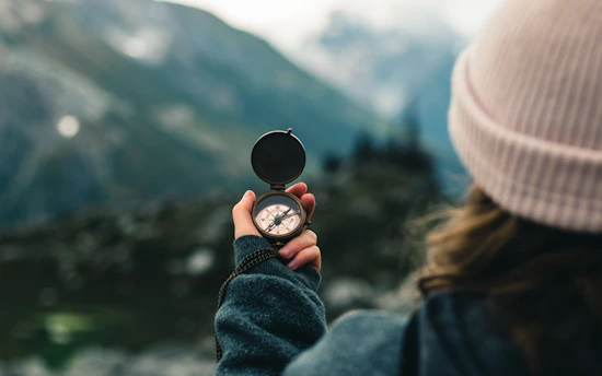 person holding black round container