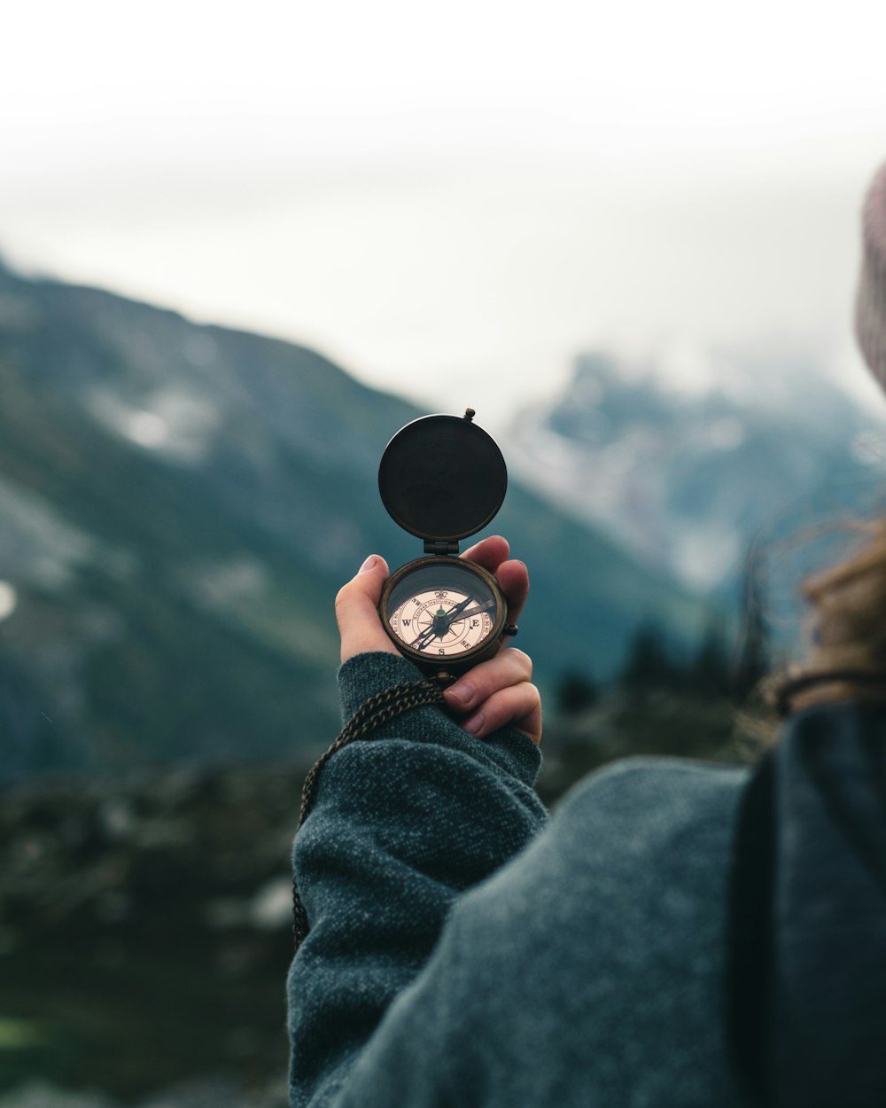 person holding black round container