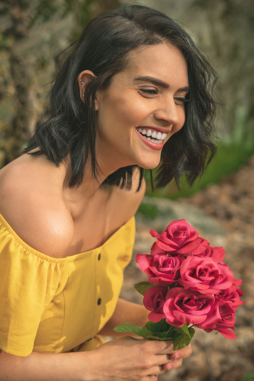 woman in yellow spaghetti strap top smiling