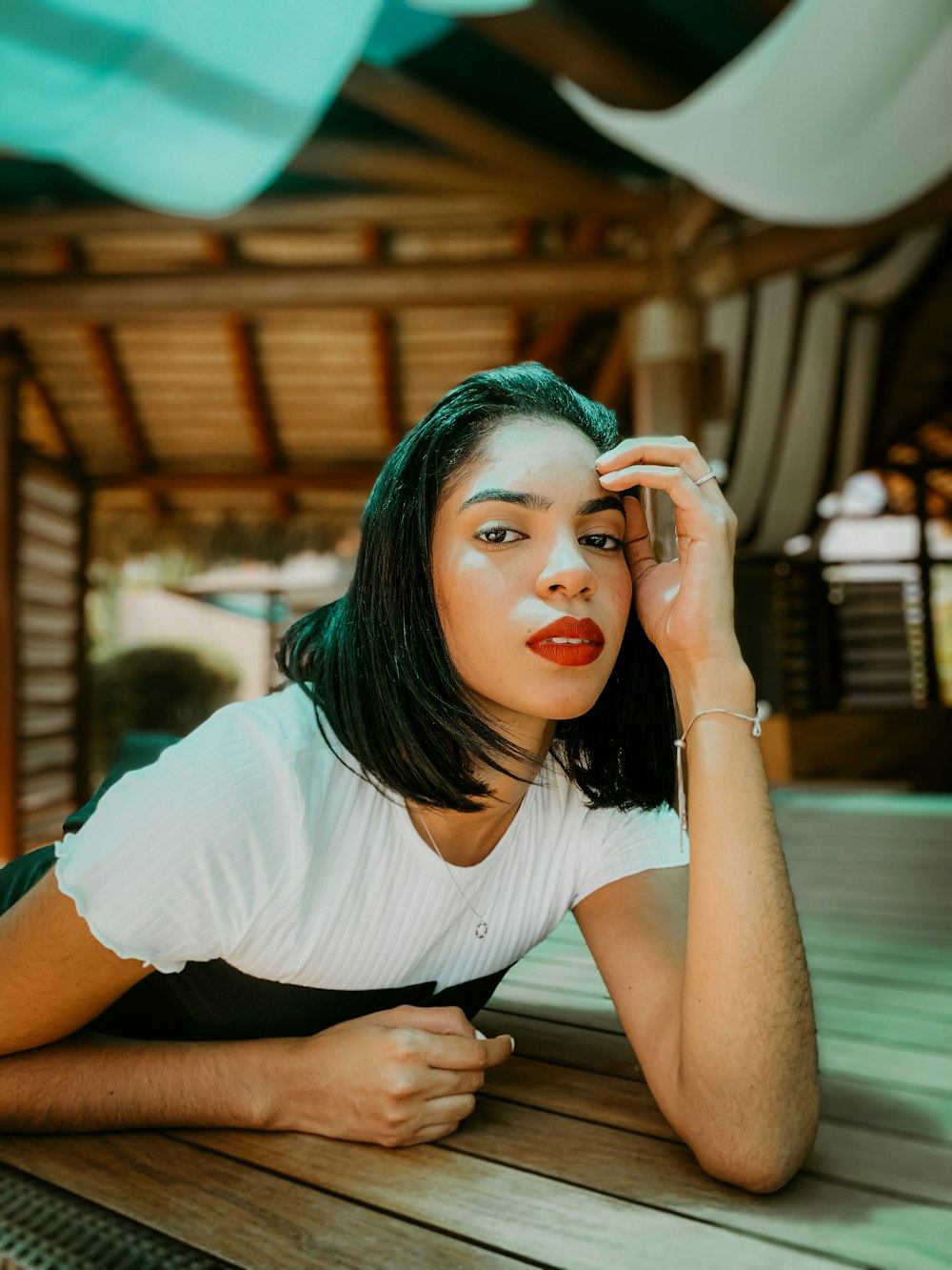 woman in white t-shirt sitting on chair