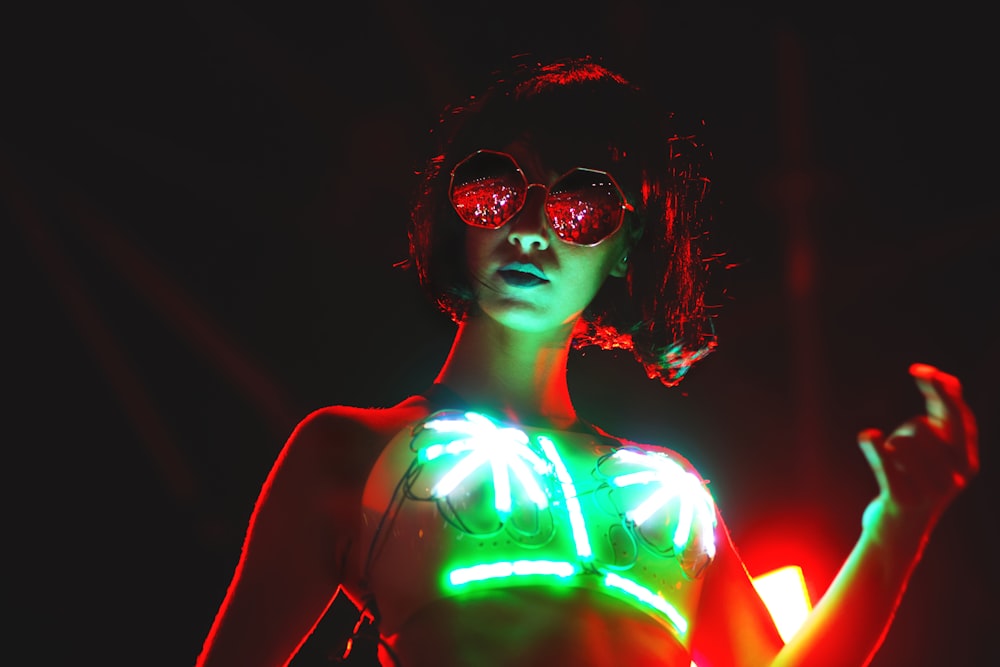 woman in black and green tank top wearing sunglasses