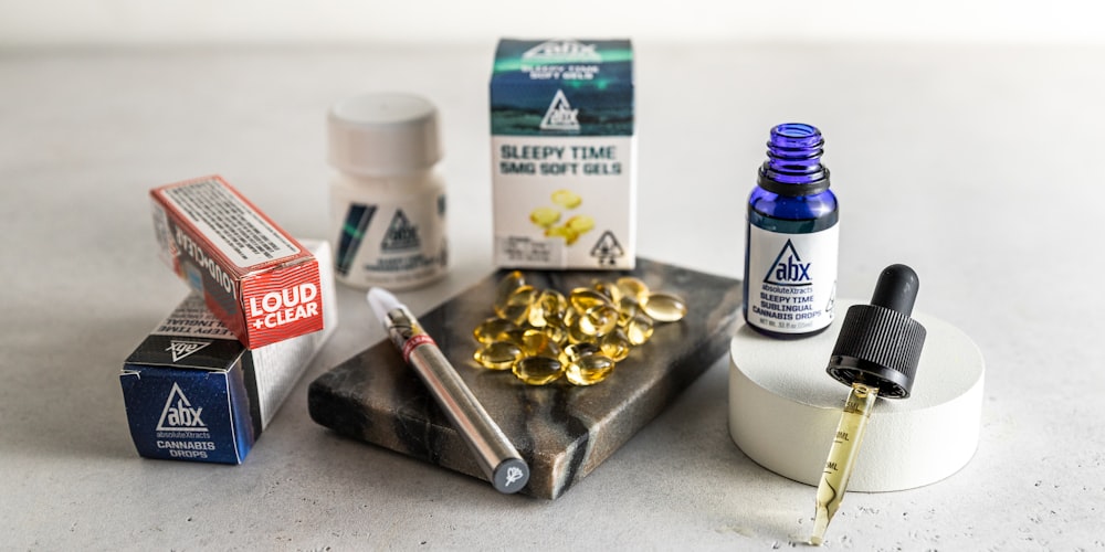 white and blue plastic bottle beside red disposable lighter