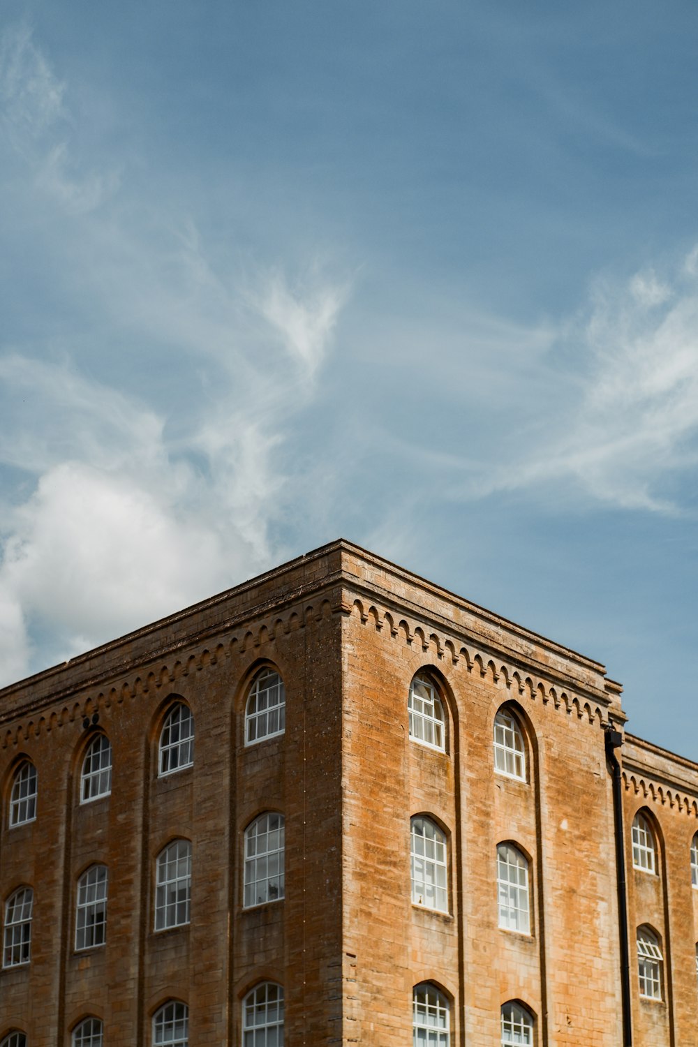 brown concrete building under blue sky during daytime