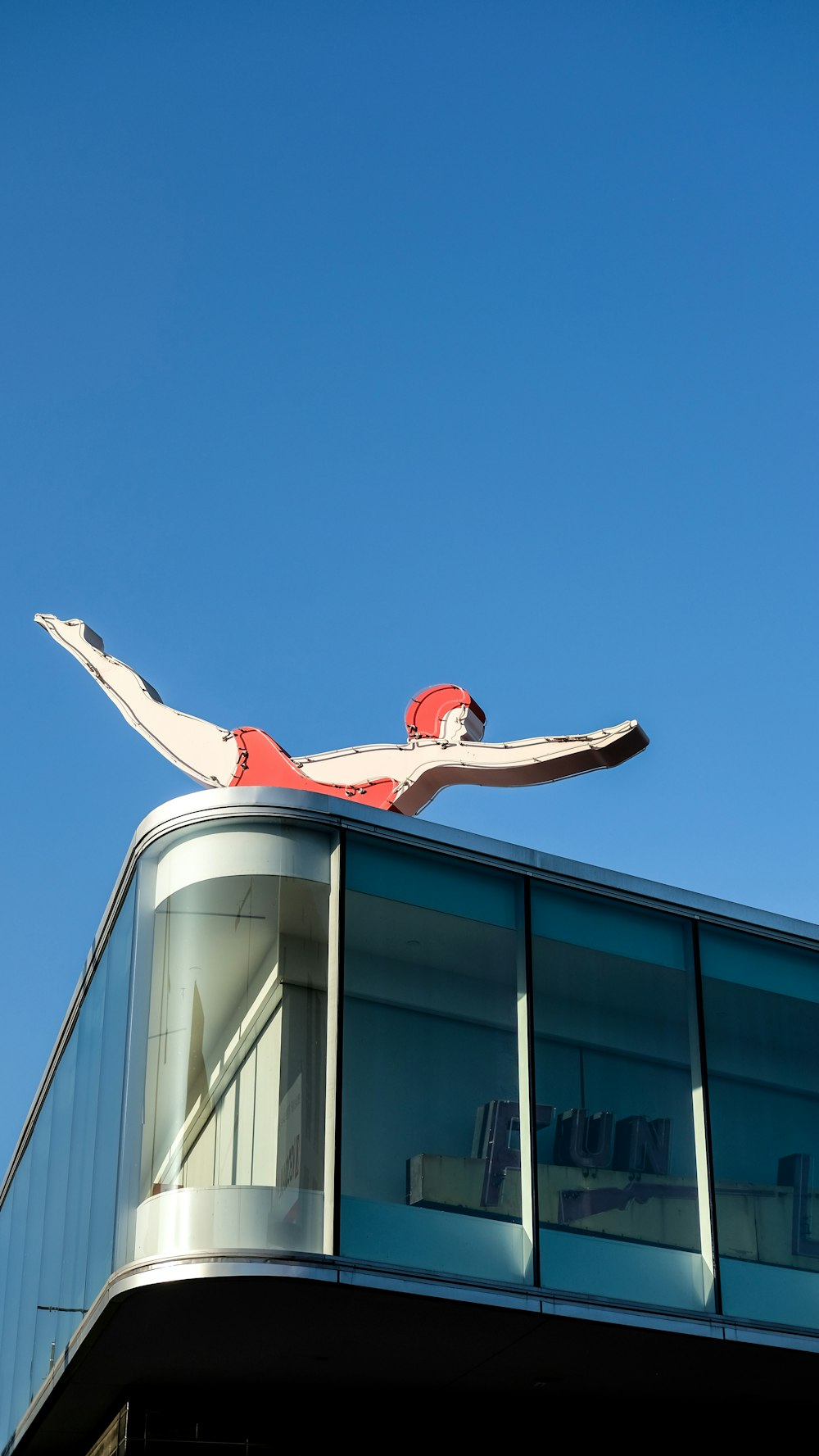 woman in red shirt and black pants sitting on white boat during daytime