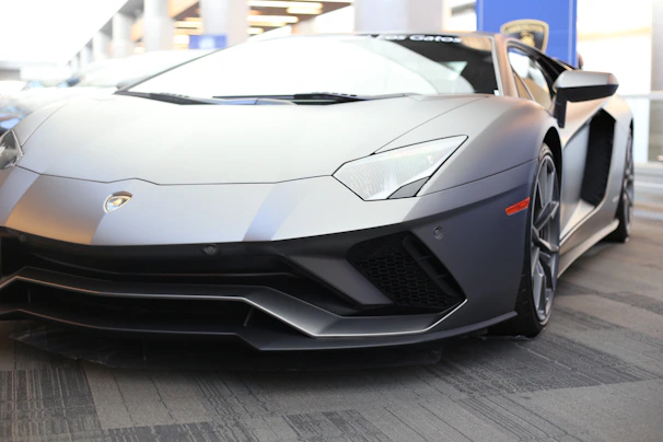 white lamborghini aventador parked on parking lot during daytime