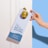 A hand with neatly manicured nails is placing a 'Please Do Not Disturb' sign on a door handle. The sign emphasizes 'Self care in progress' and is decorated with small stars. The environment is serene and minimalistic with a soothing color palette.